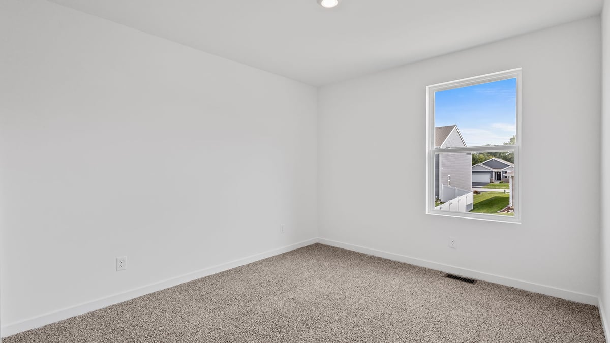 Bedroom with carpeted floors and a side window.