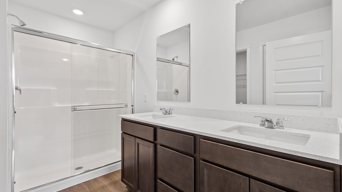 Dual vanity sink with a walk-in shower.