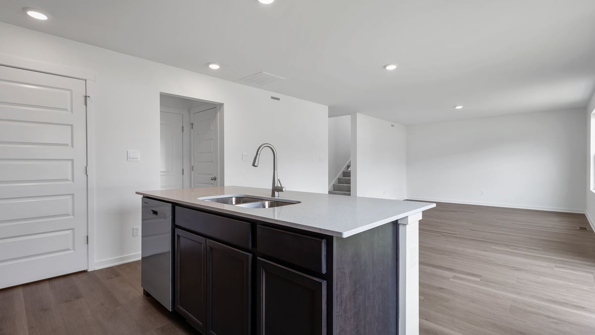 Kitchen island with quartz countertops and an open space.