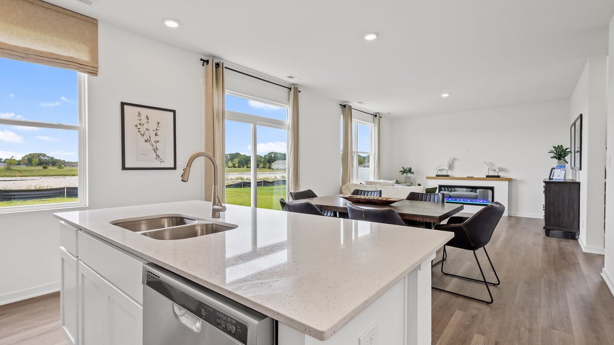 Kitchen with quartz countertops and view of windows.