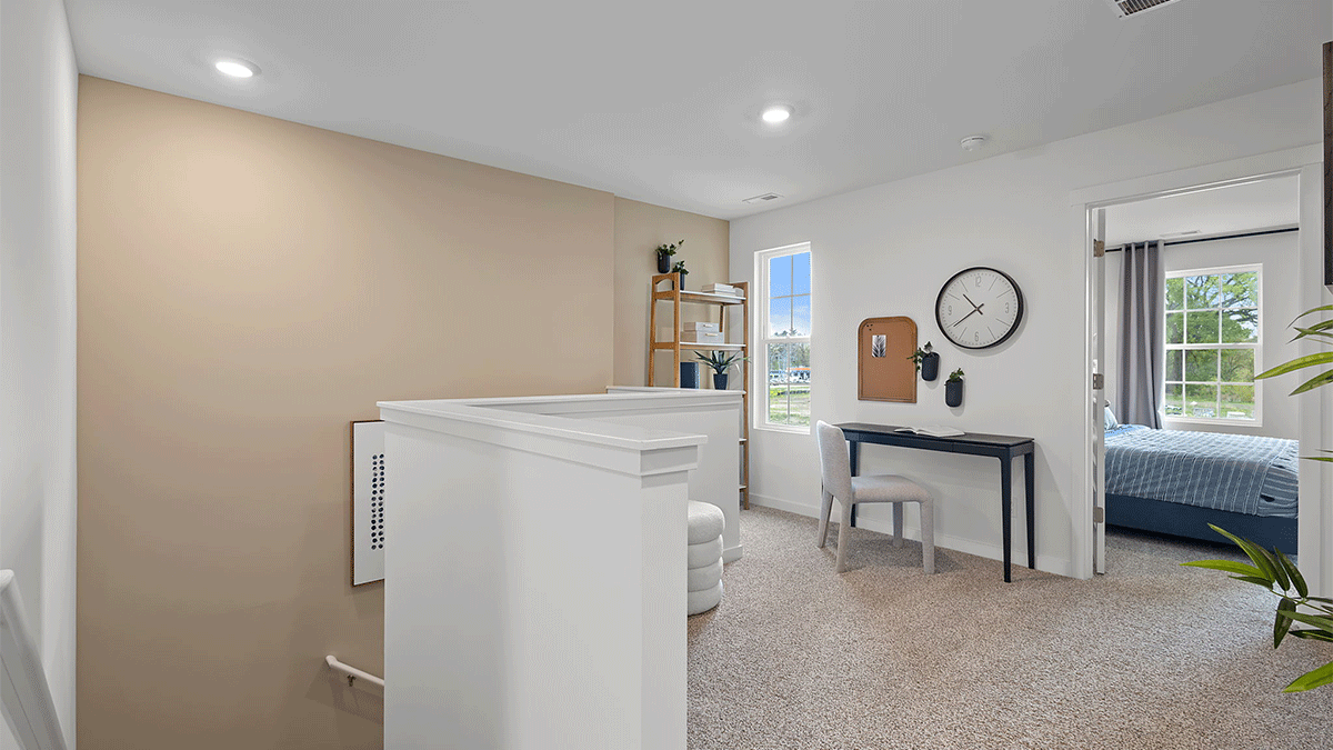 Upstairs loft area with carpeted floors.