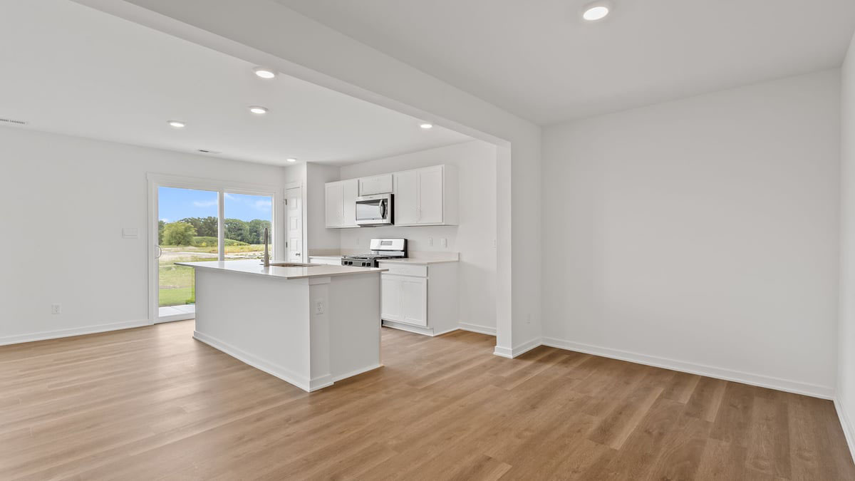 Kitchen and dining area with hard wood floors.