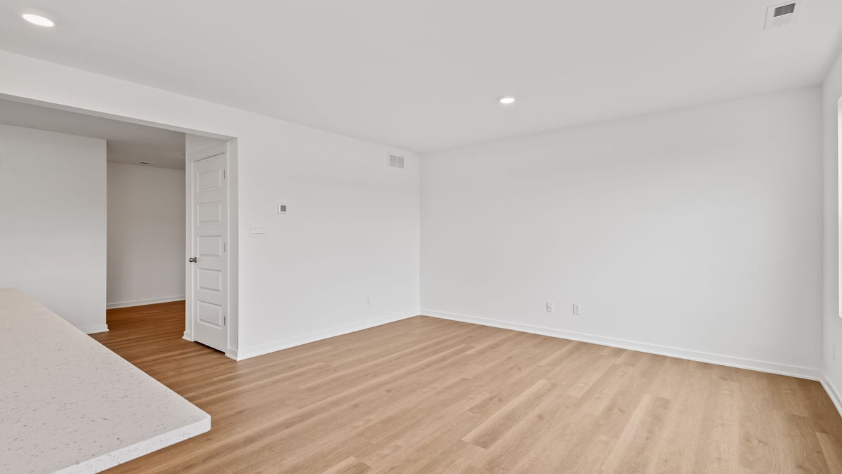 Living area with hard wood floors open layout.