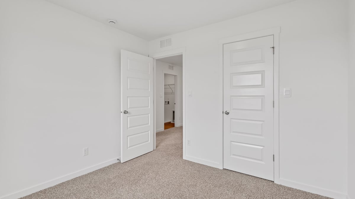 Bedroom with carpeted floors and a closet.