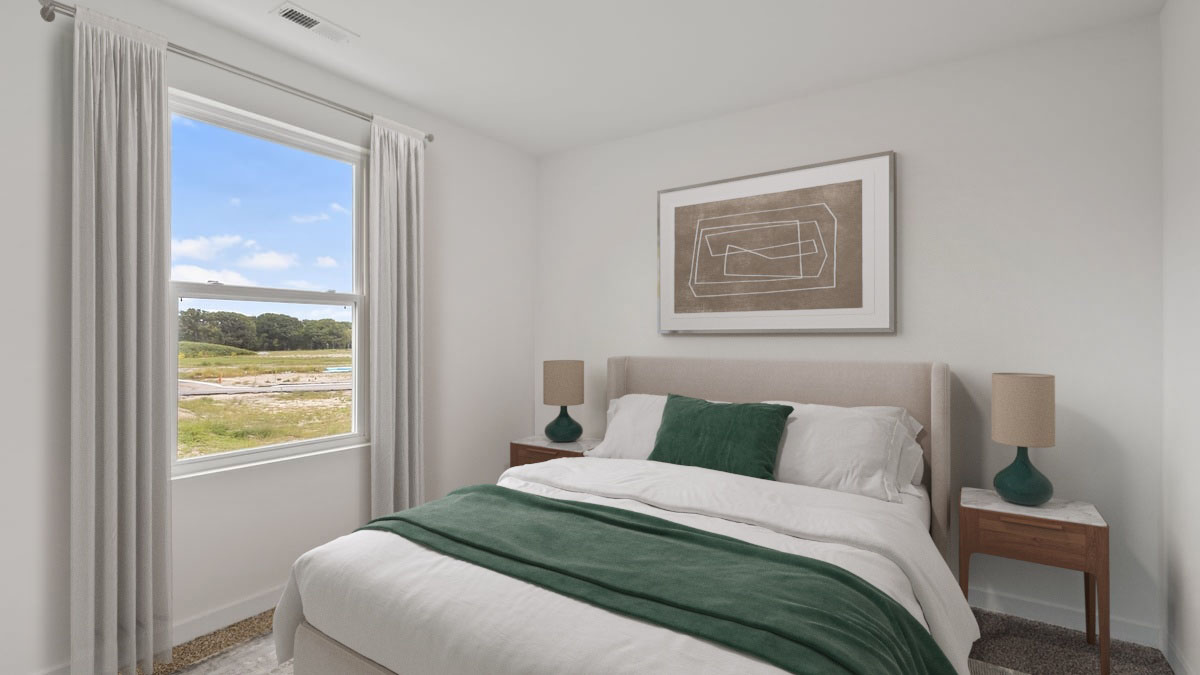 Bedroom with a side window and carpeted floors.