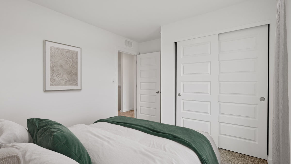 Bedroom with carpeted floors and a closet.