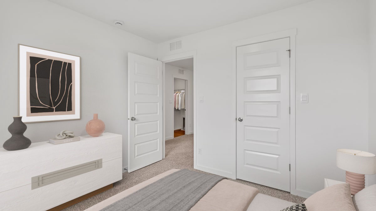 Bedroom with carpeted floors and a closet.