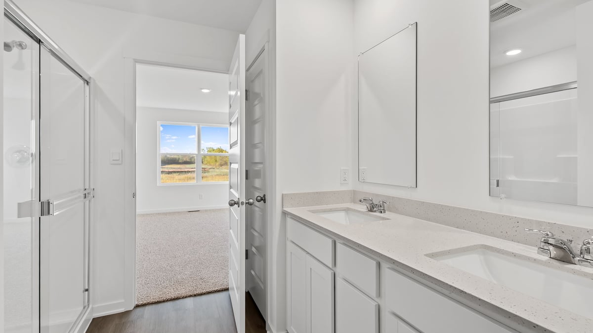 Walk in shower and dual vanity sinks.