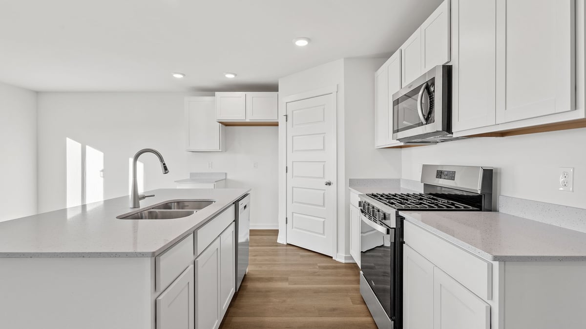 Kitchen with white cabinetry and island.