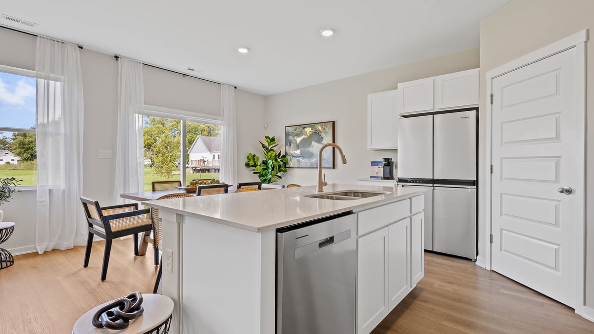 Kitchen with quartz countertops and viewing dining area.