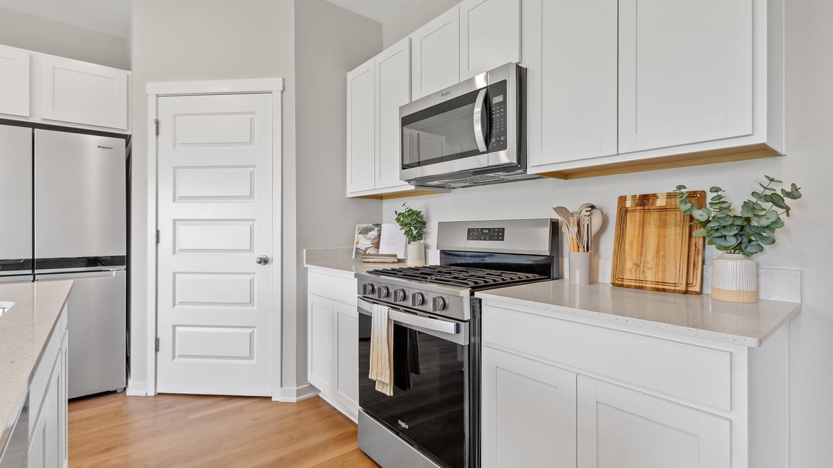 Kitchen with white cabinets and appliances.