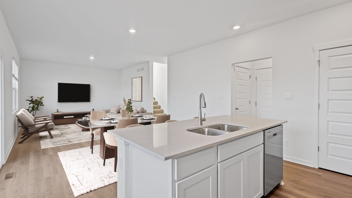 Kitchen island with quartz countertops and hard wood flooring.