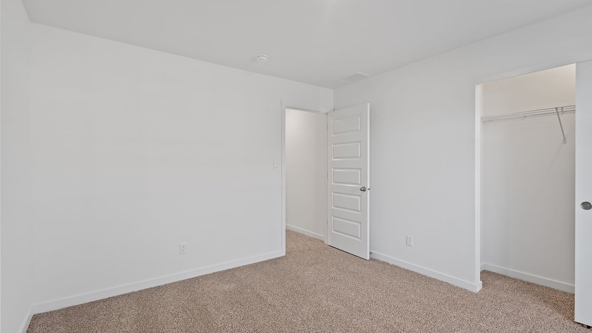 Bedroom with carpeted floors with a closet.
