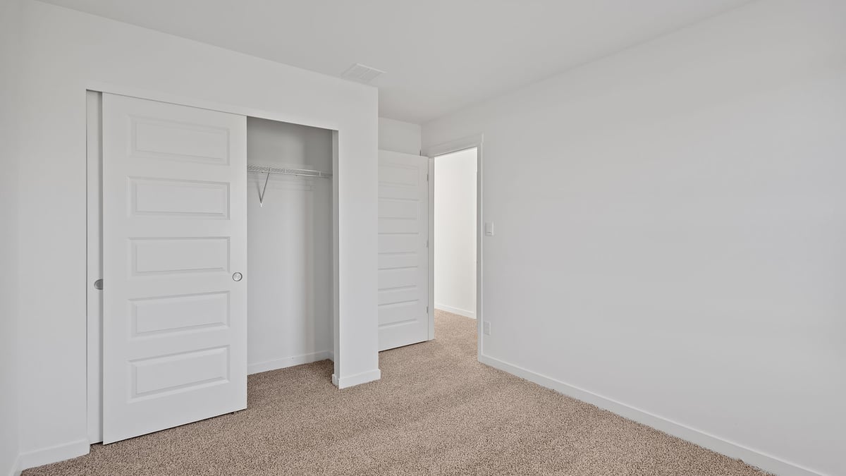 Bedroom with carpeted floors with a closet.
