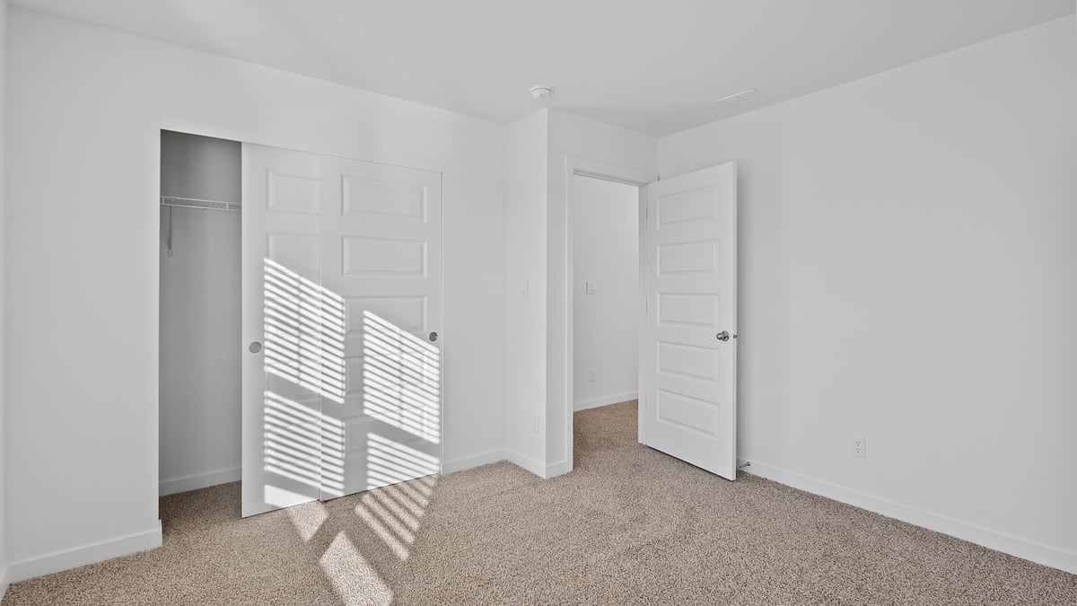 Bedroom with carpeted floors and a closet.