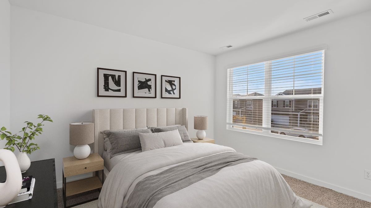 Bedroom with carpeted floors with a big window.