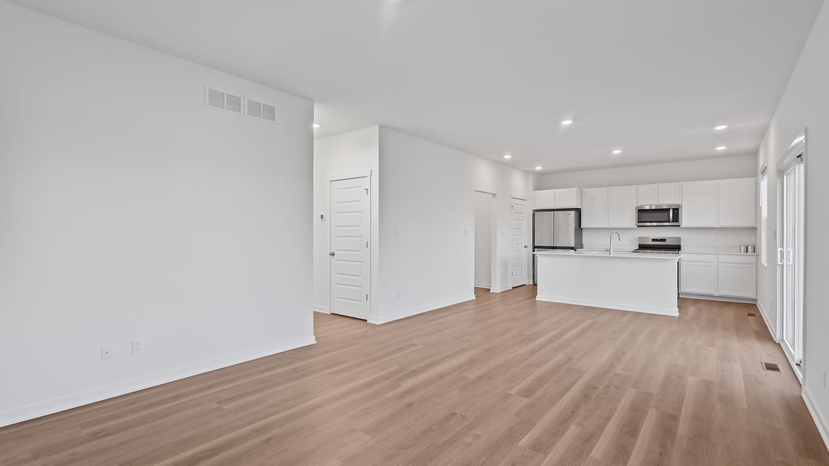 Living room area with hard wood flooring and great space.