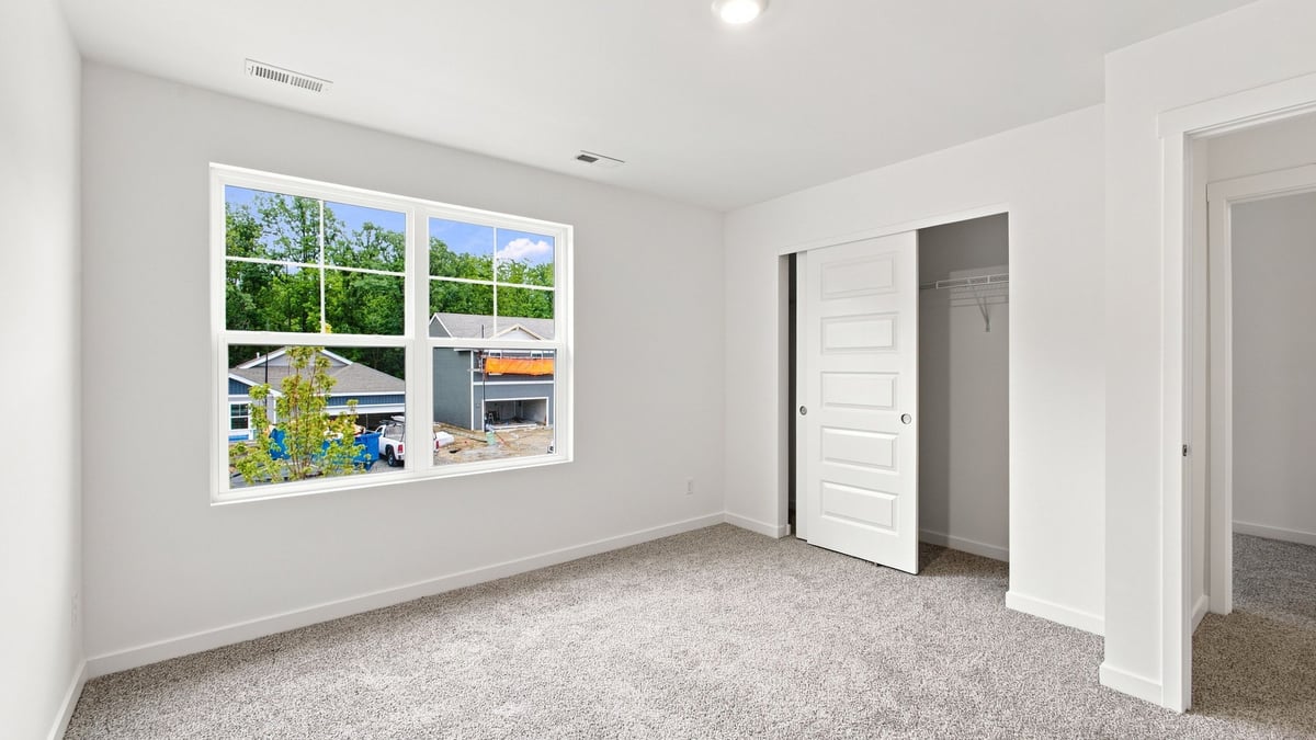 Bedroom with carpeted floors and closet.
