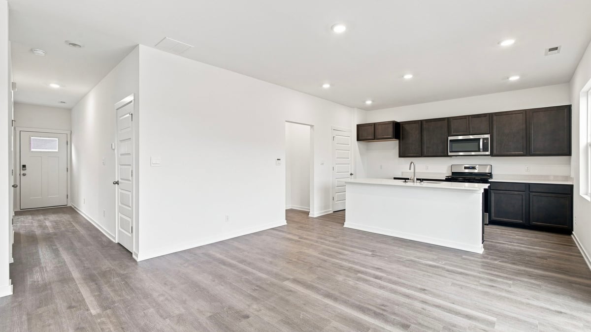 Open great room, dining, and kitchen area.