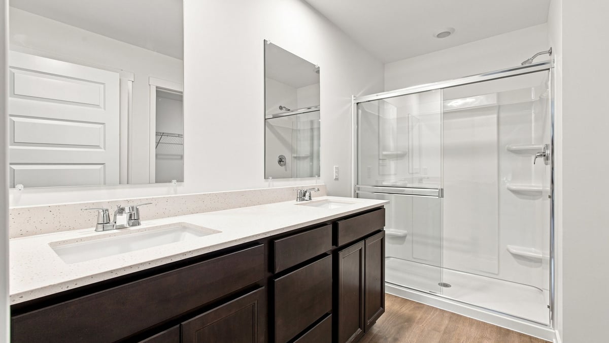 Primary bathroom with dual vanity sinks.