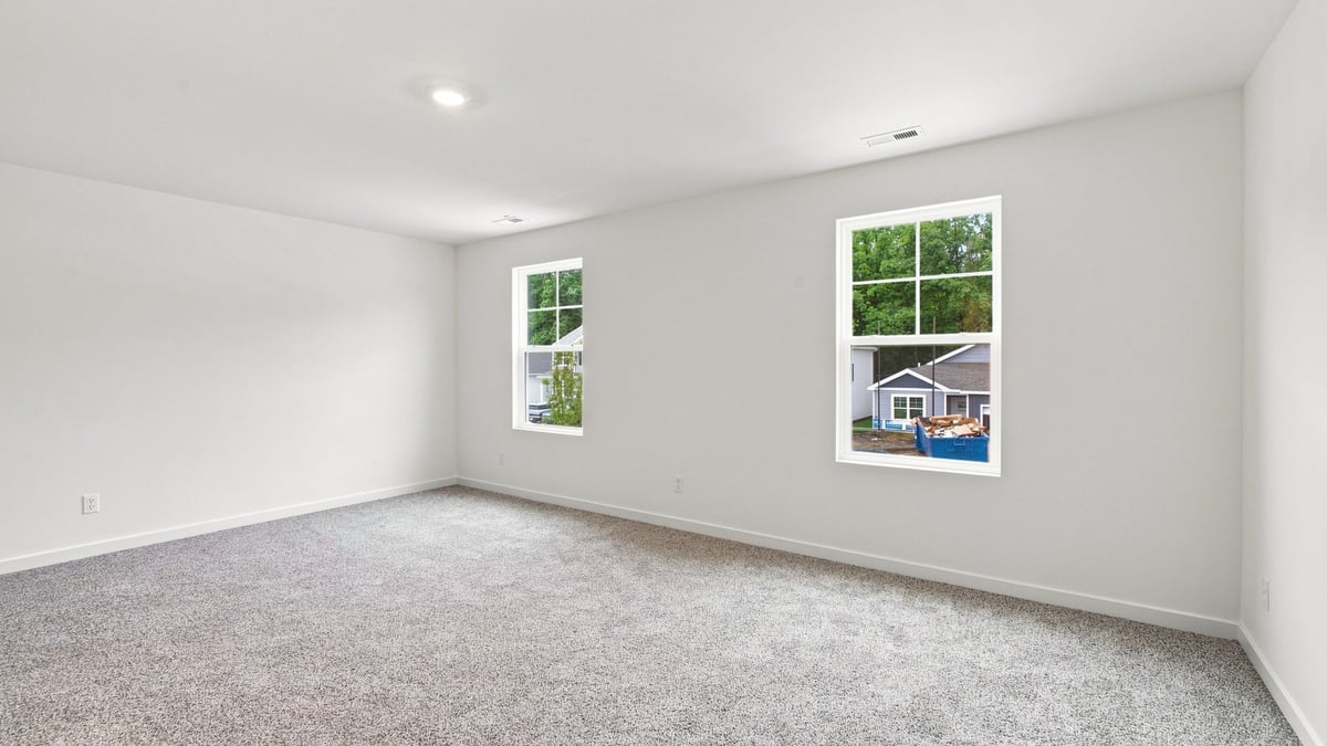 Primary bedroom with two side windows.