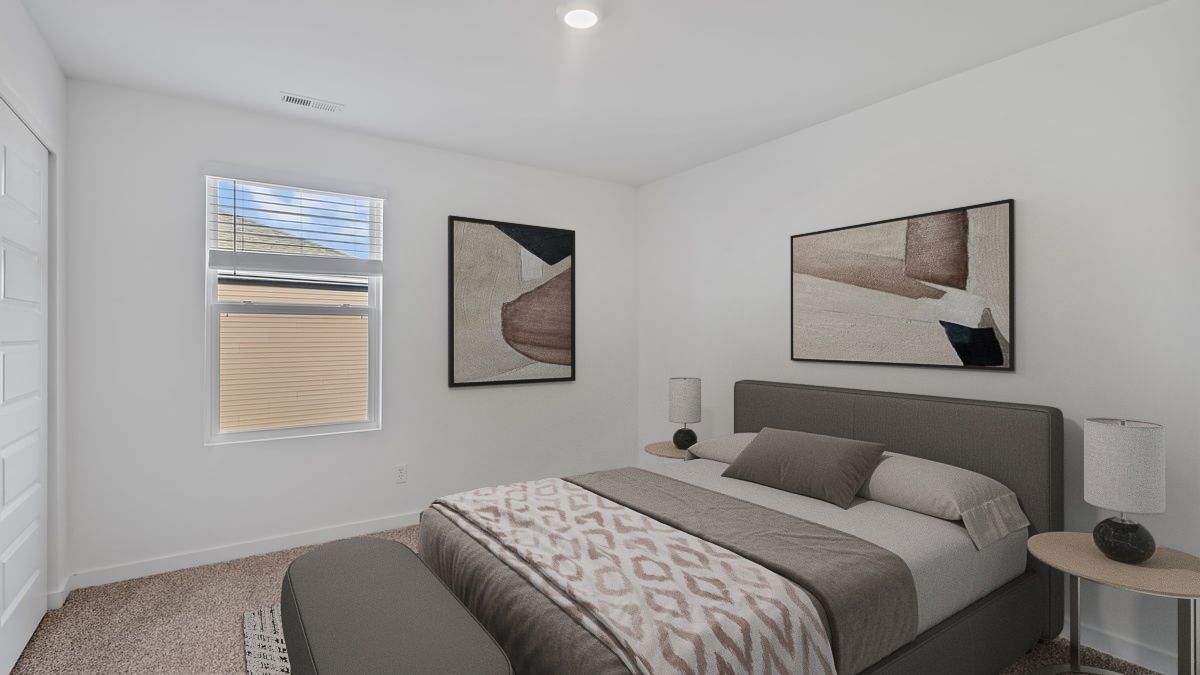 Bedroom with a side window and carpeted floors.