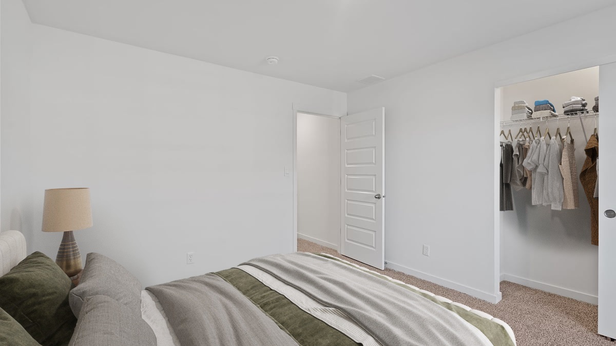 Bedroom with carpeted floors and a closet.