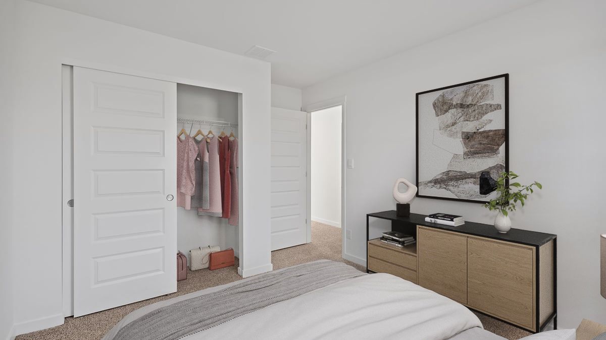 Bedroom with carpeted floors with a closet.