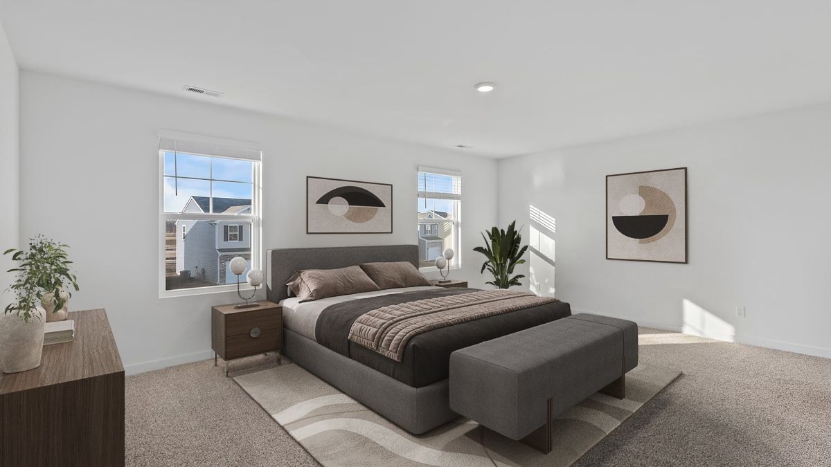 Primary bedroom with carpeted floors, great space, and two windows.