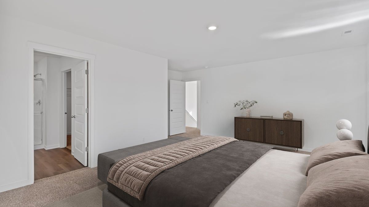Primary bedroom with carpeted floors and great space.