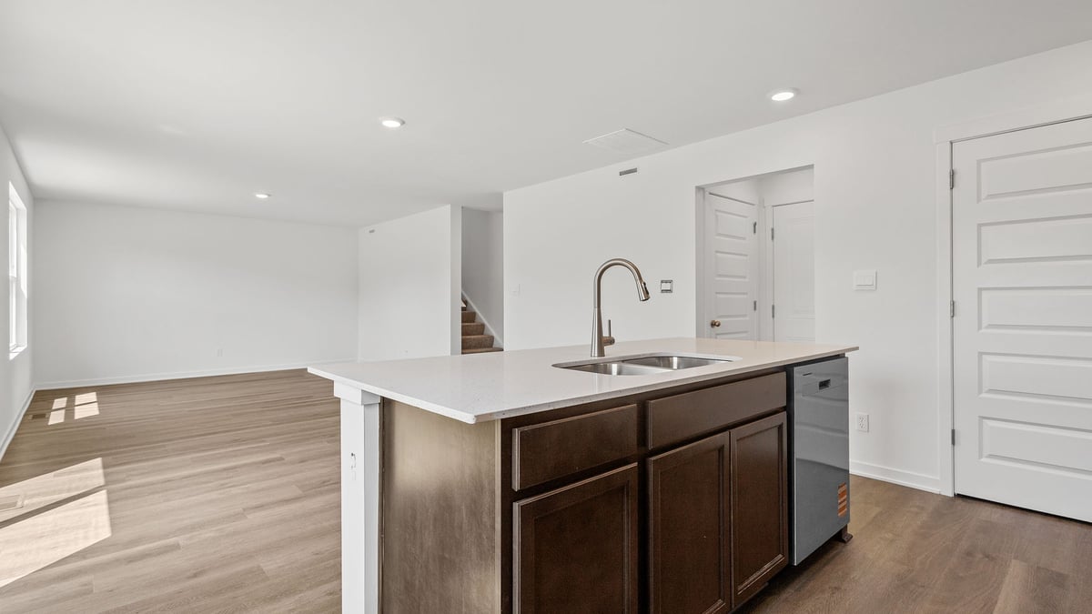 Kitchen with white cabinetry and great living room space.