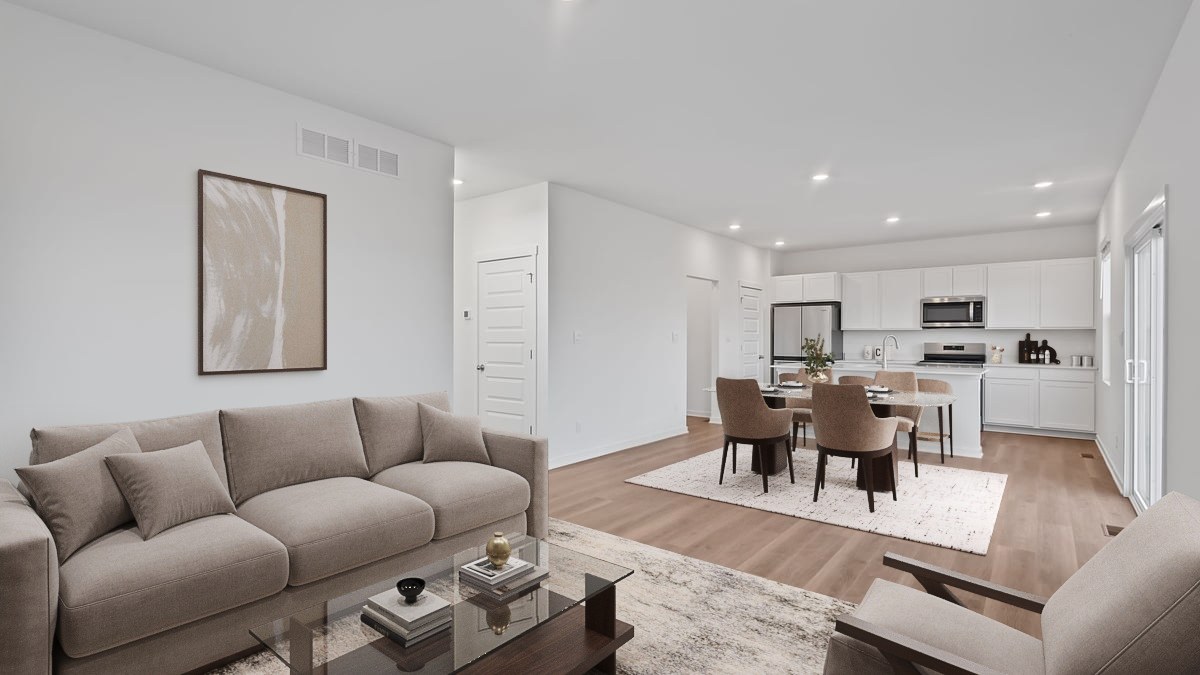 Living room, dining, and kitchen area with hard wood flooring and great space.