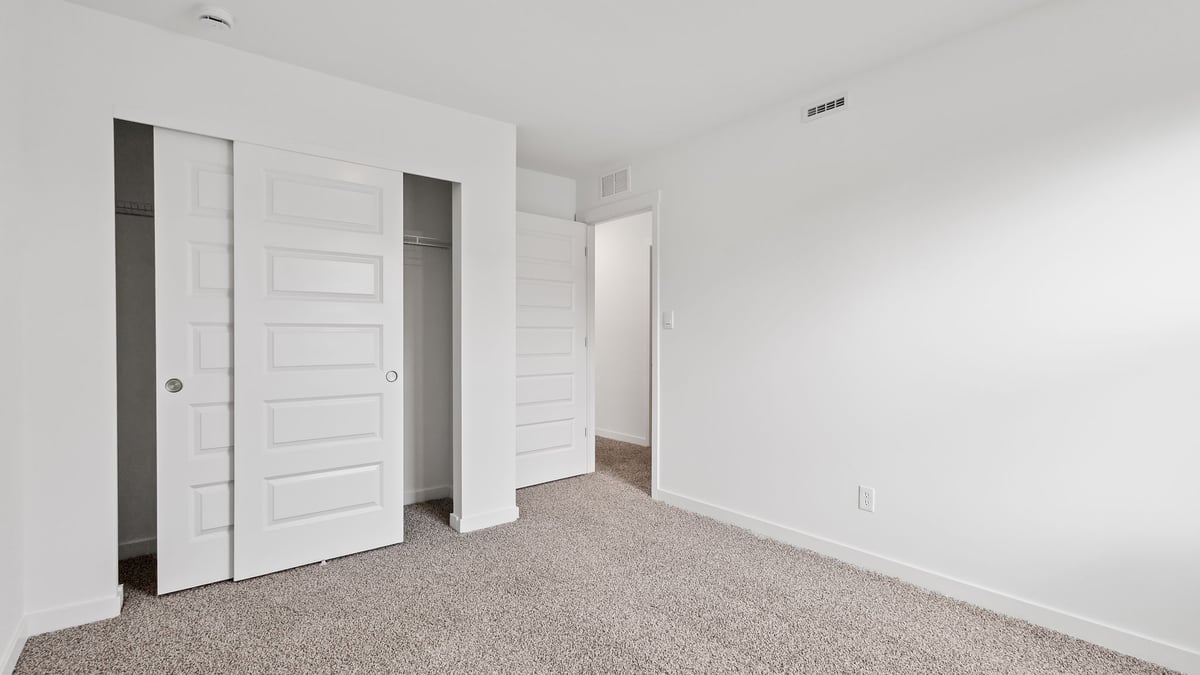 Bedroom with carpet and a closet.