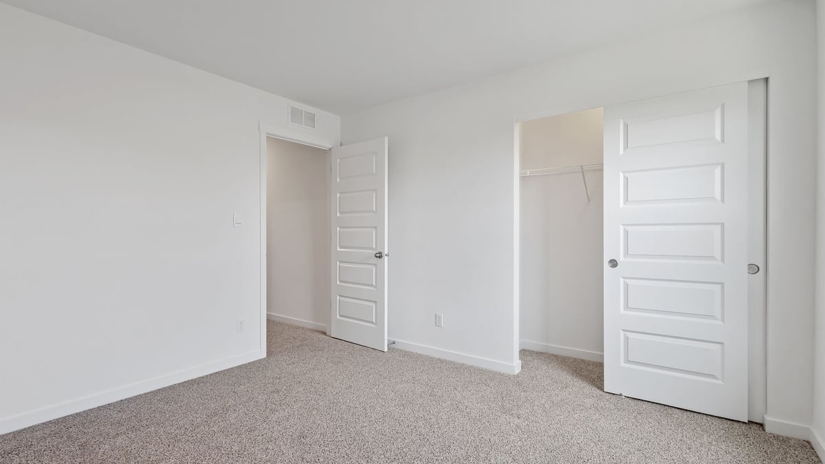 Bedroom with carpet and bathroom.