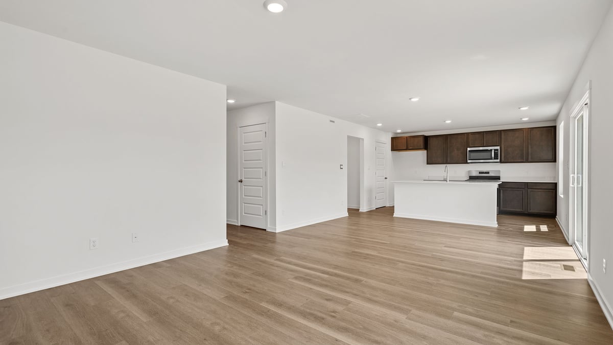 Living room with view of dining area and kitchen area.