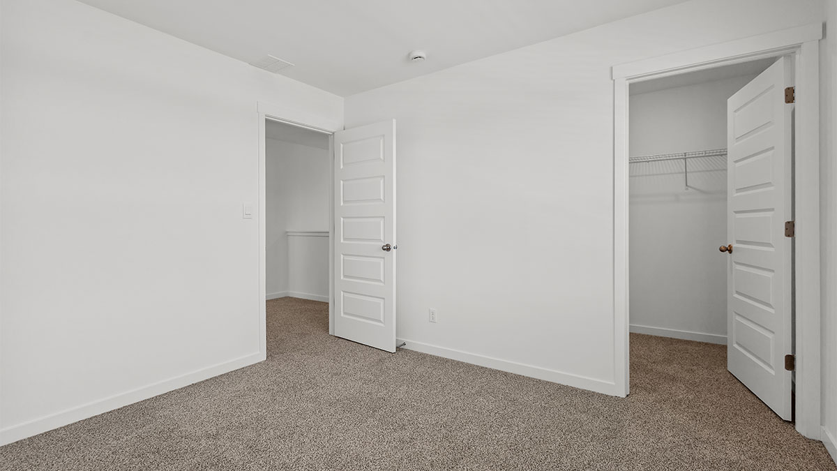 Bedroom with carpet and a closet.