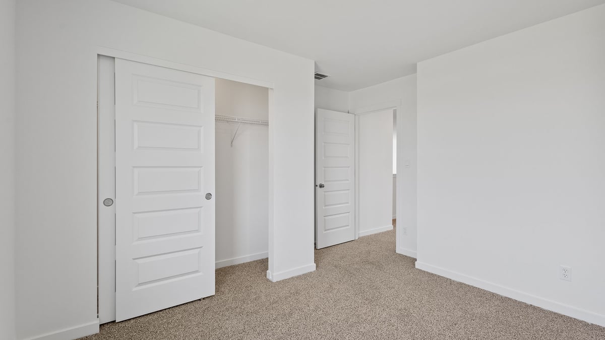 Bedroom with carpet and a closet.
