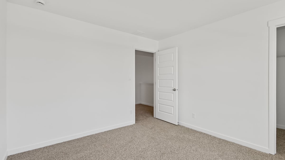 Bedroom with carpet and closet.
