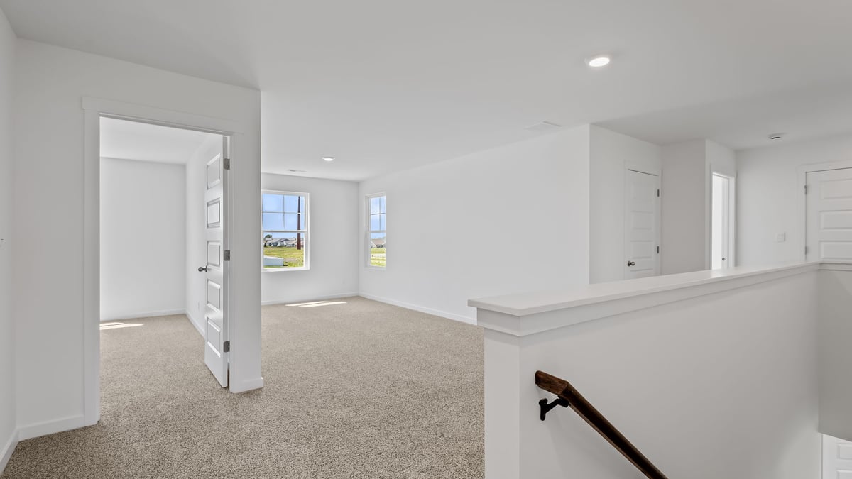 Top of staircase on second level viewing loft room.