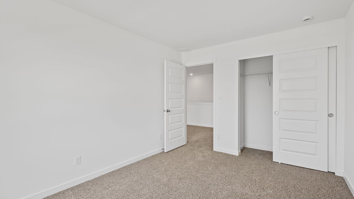 Bedroom with carpet and closet.