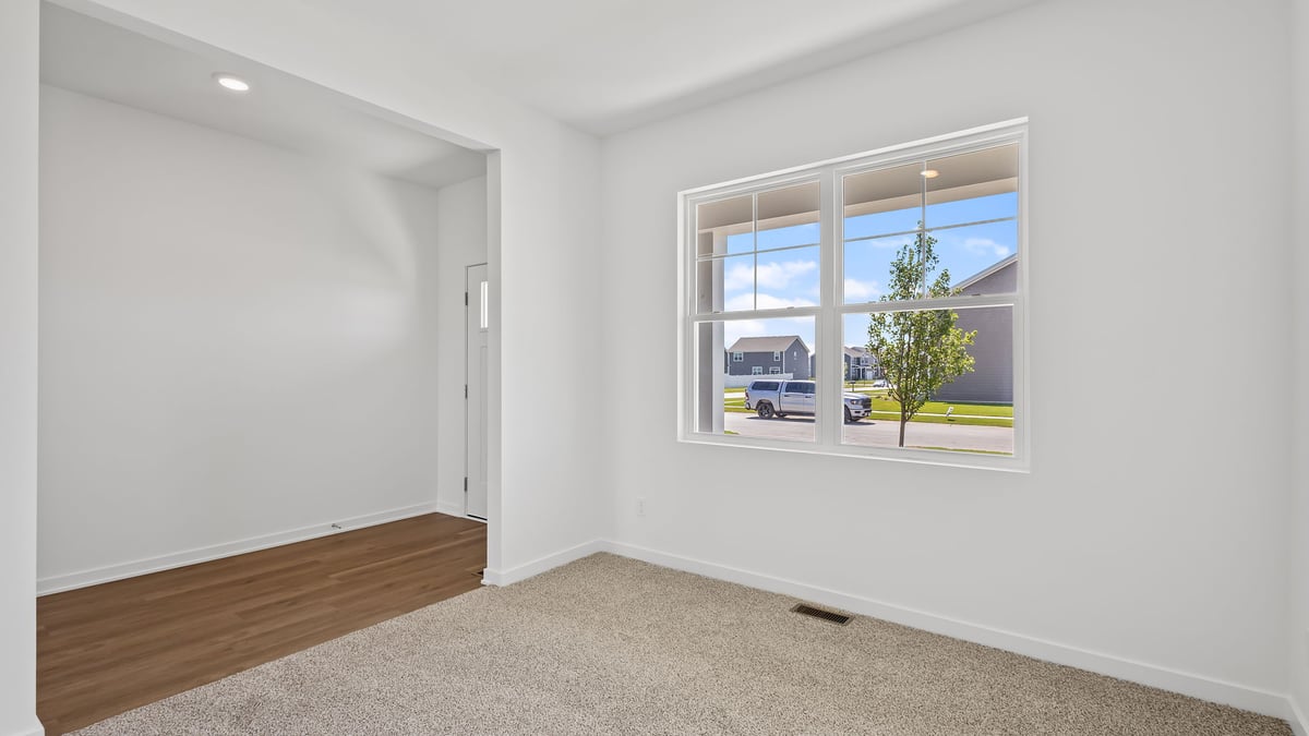 Front room with carpet and big window.