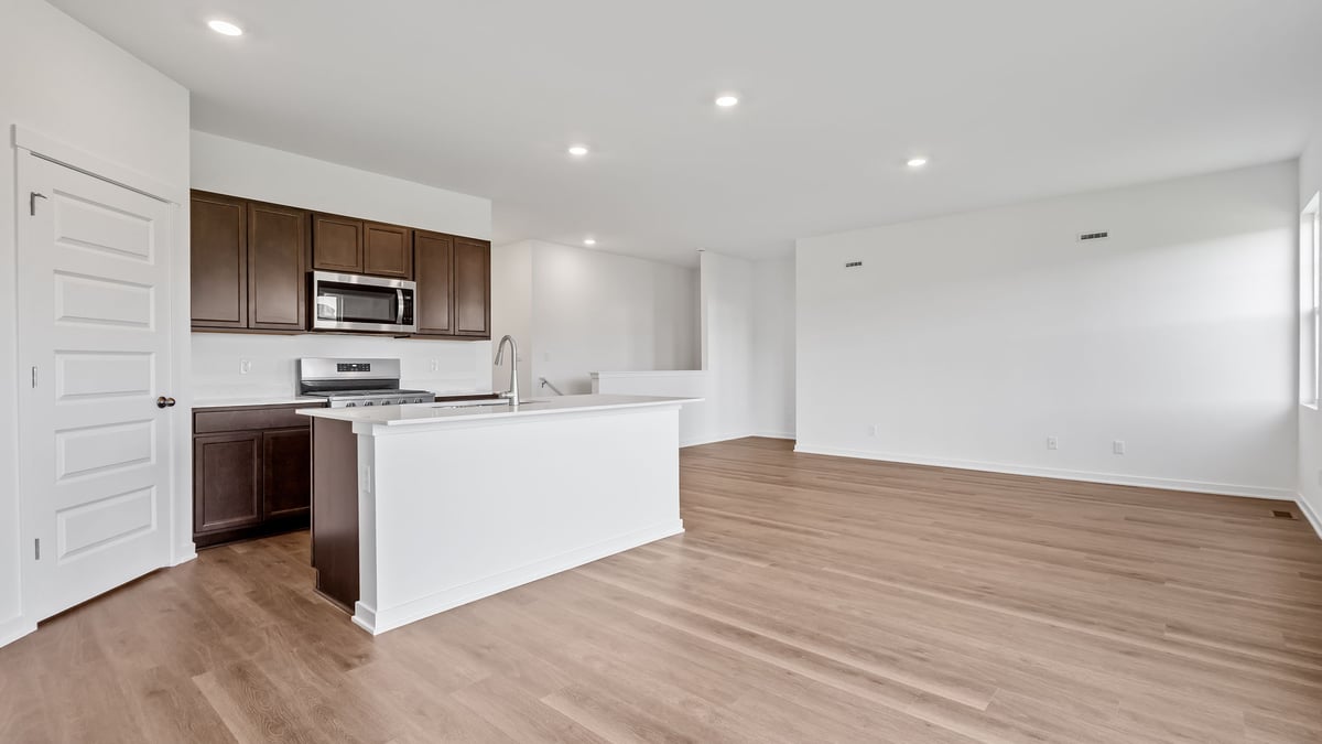 Kitchen and dining area with hard wood flooring.