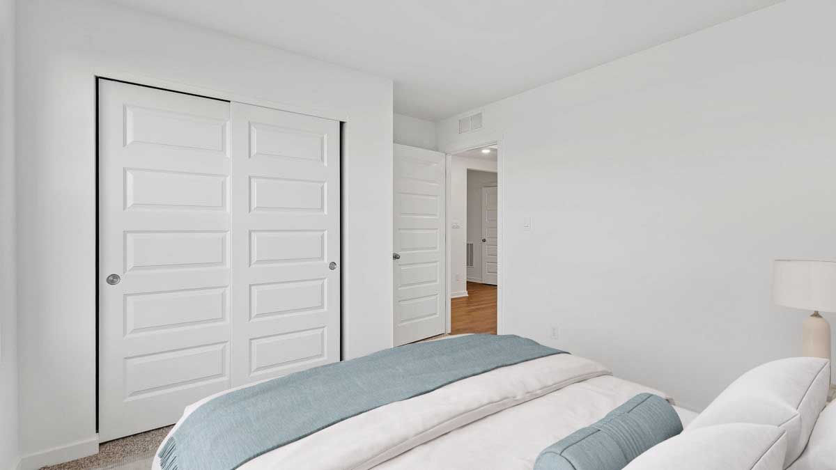 Bedroom with a closet and carpeted floors.