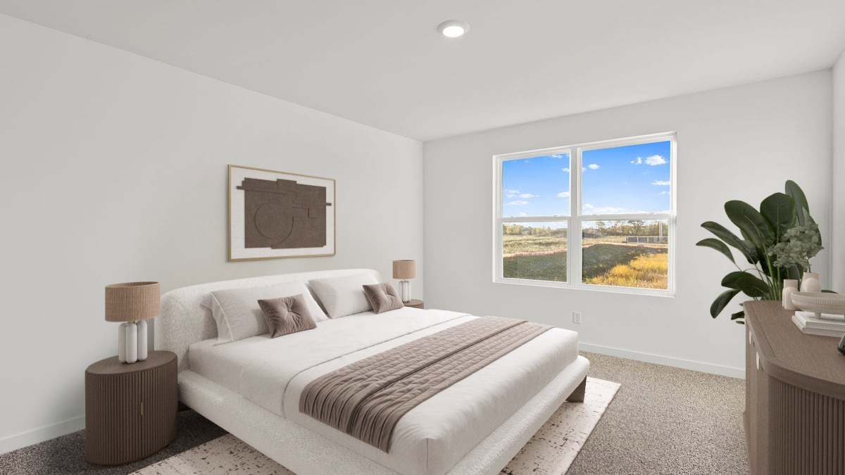 Primary bedroom with a big window and carpeted floors.