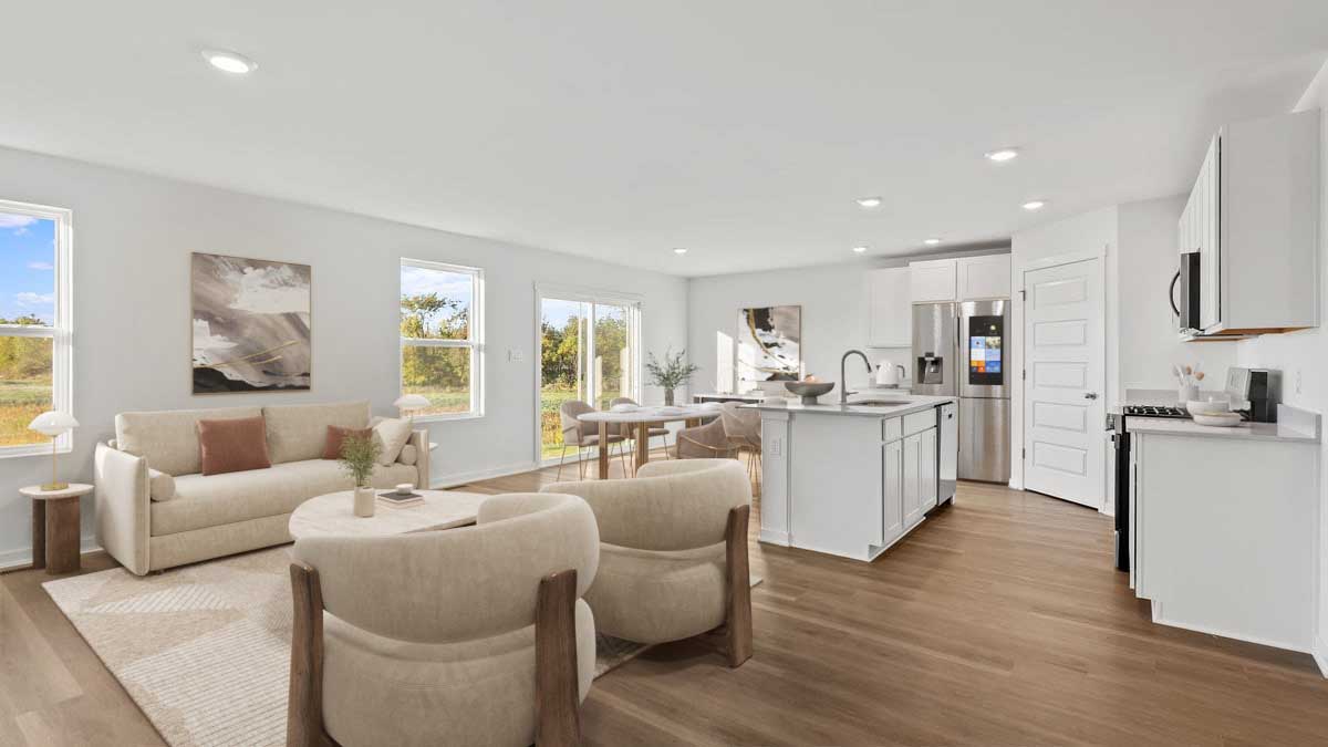 Living room area with an open layout with hard wood floors with windows.