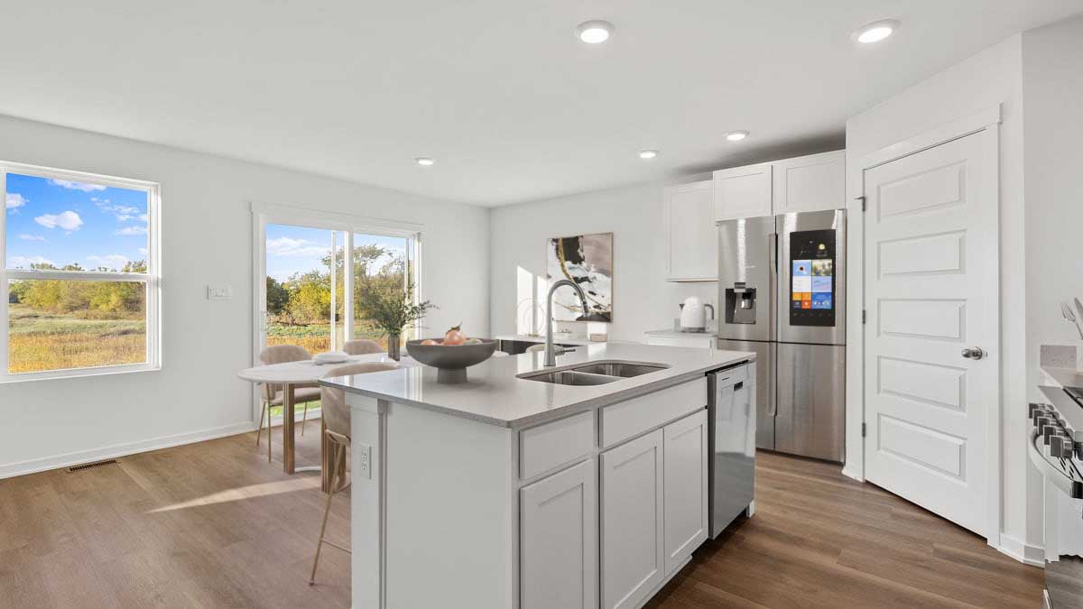 Kitchen island with quartz countertops with hard wood floors.