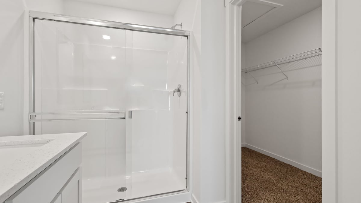 Primary walk-in shower and walk-in closet.