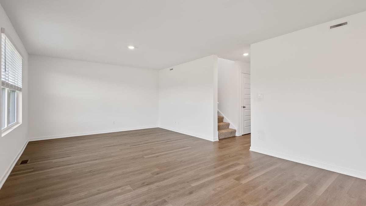Living room area with hard wood flooring and great space.