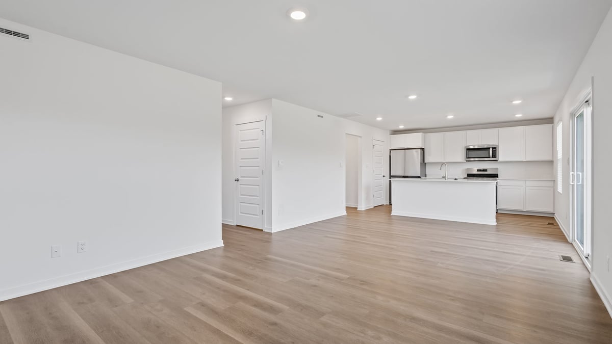 Living room area with hard wood floors and dining area.