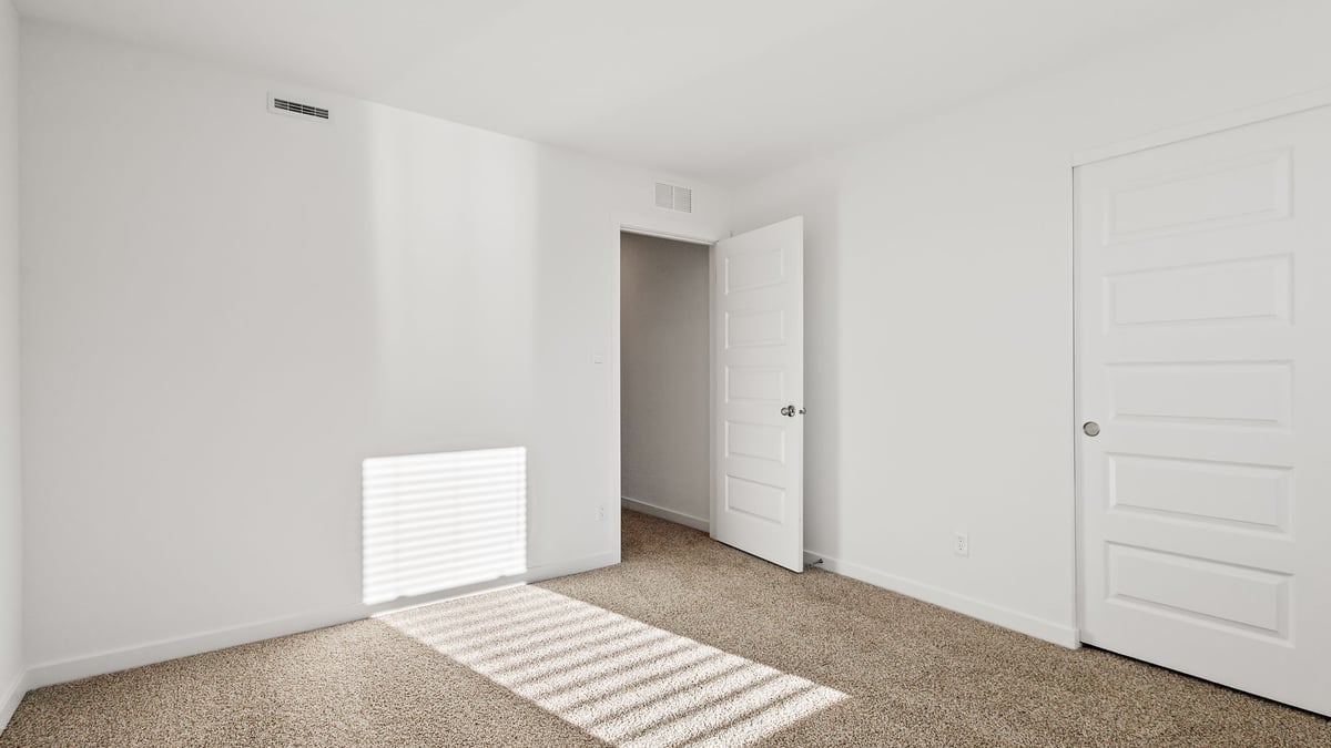Bedroom with a closet and carpeted floors.